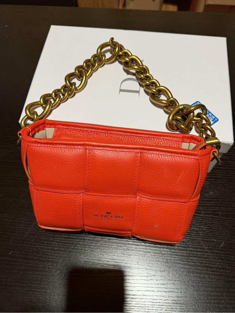 Monica Bini Orange pebbled small shoulder bag zip closure gold chain strap.